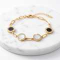 Bracelet stainless steel doré avec médaillons noirs et blancs